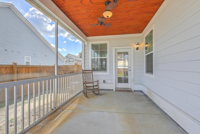 view of patio with fence and ceiling fan