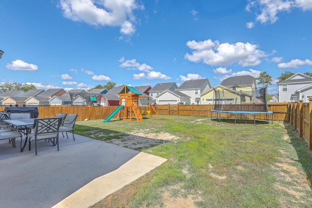 view of yard featuring a patio, a fenced backyard, a playground, a trampoline, and a residential view