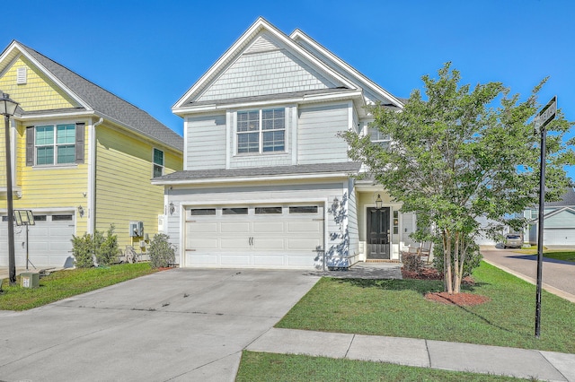 view of front facade with a garage, driveway, and a front yard