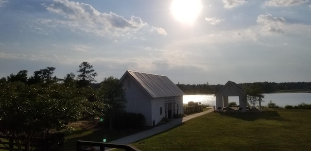 exterior space with an outdoor structure and a water view