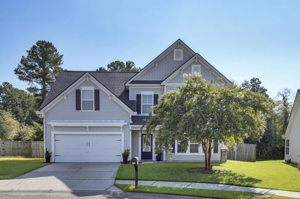 view of front of home featuring a front yard and a garage