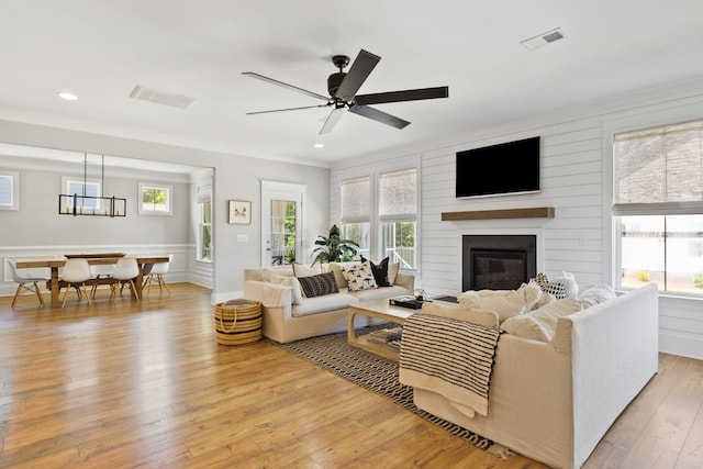 2828 Wagner Way, Mount Pleasant, SC 29466 - living area with light wood-style floors, a large fireplace, ceiling fan, recessed lighting, and crown molding