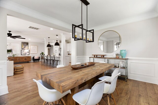 2828 Wagner Way, Mount Pleasant, SC 29466 - dining area featuring light wood-style flooring, ceiling fan, recessed lighting, a wainscoted wall, and ornamental molding