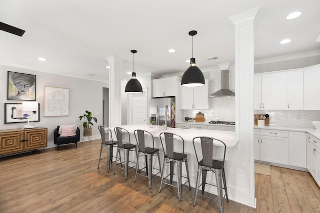 2828 Wagner Way, Mount Pleasant, SC 29466 - kitchen with wall chimney exhaust hood, stainless steel fridge with ice dispenser, decorative backsplash, light countertops, and recessed lighting