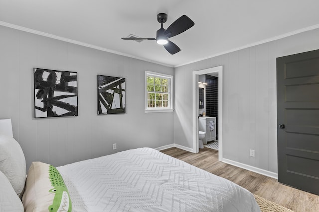 bedroom featuring ornamental molding, wood finished floors, baseboards, connected bathroom, and ceiling fan