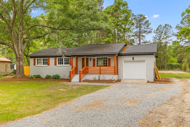 ranch-style home with brick siding, driveway, a garage, and covered porch