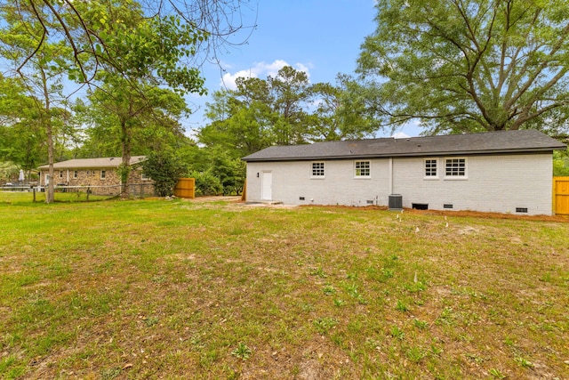 back of house featuring crawl space and central AC