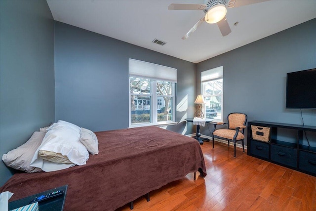 bedroom with wood-type flooring and ceiling fan