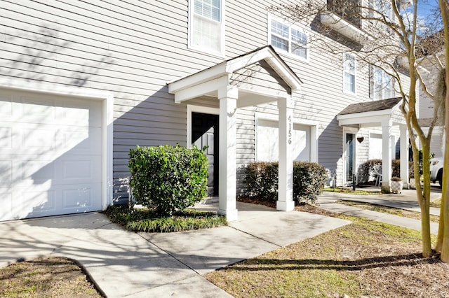 doorway to property with a garage