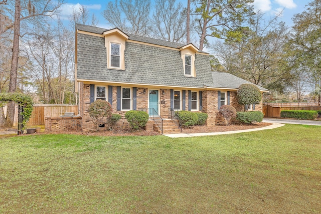103 Laurens Ct, Summerville, SC 29485 - dutch colonial featuring a front lawn, fence, brick siding, and roof with shingles