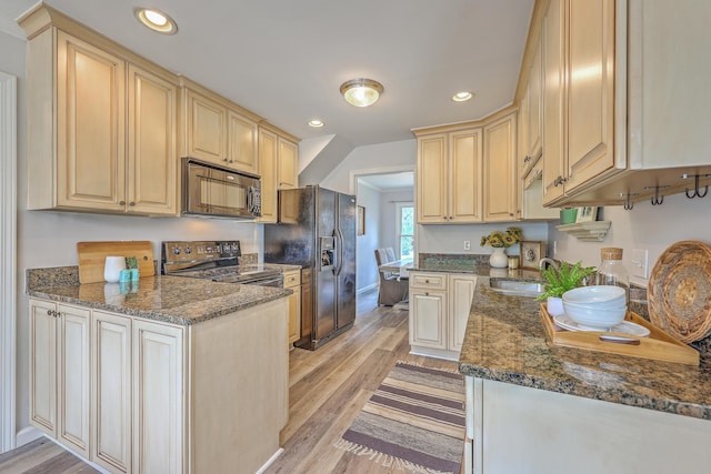 103 Laurens Ct, Summerville, SC 29485 - kitchen featuring black appliances, dark stone countertops, recessed lighting, light wood-style floors, and a peninsula