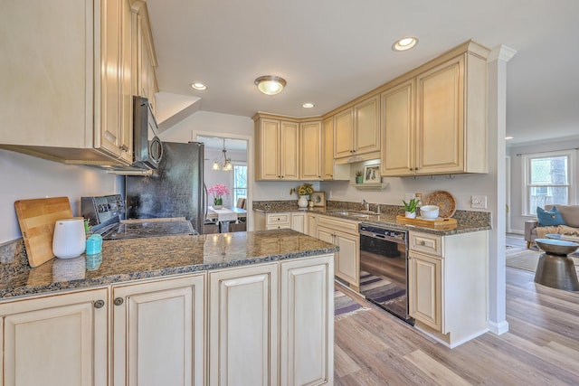 103 Laurens Ct, Summerville, SC 29485 - kitchen with dark stone countertops, black appliances, light wood-style floors, and a sink