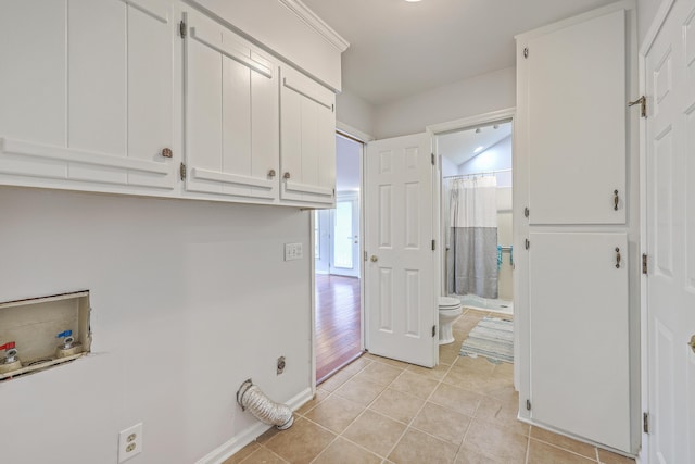 103 Laurens Ct, Summerville, SC 29485 - washroom featuring light tile patterned floors, baseboards, cabinet space, and washer hookup