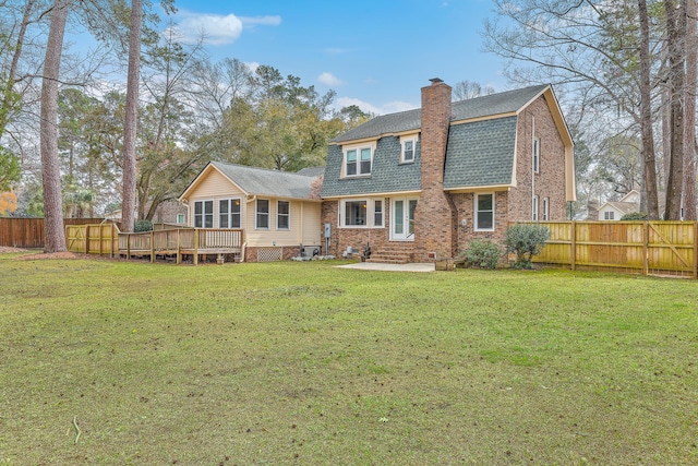 103 Laurens Ct, Summerville, SC 29485 - back of house featuring a shingled roof, fence, a gambrel roof, a chimney, and a yard