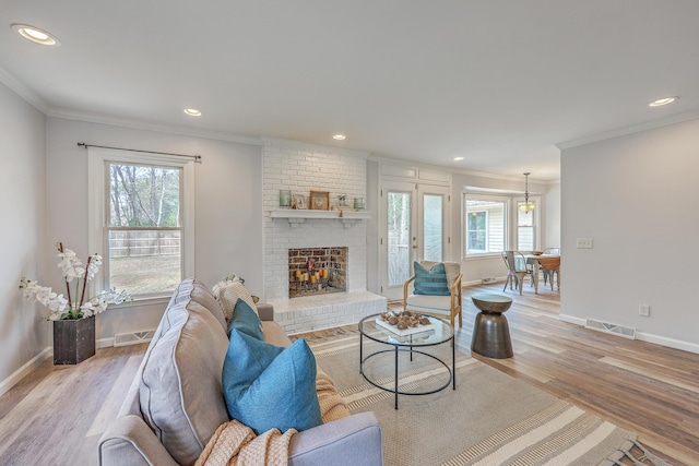 103 Laurens Ct, Summerville, SC 29485 - living room featuring a brick fireplace, light wood-style flooring, and visible vents