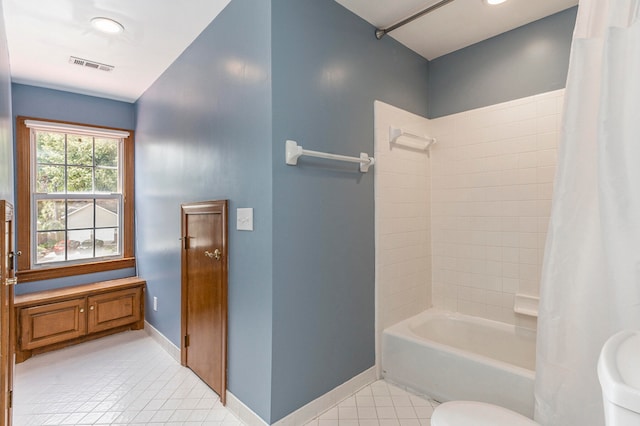 bathroom with toilet, tile patterned floors, and shower / bath combination with curtain