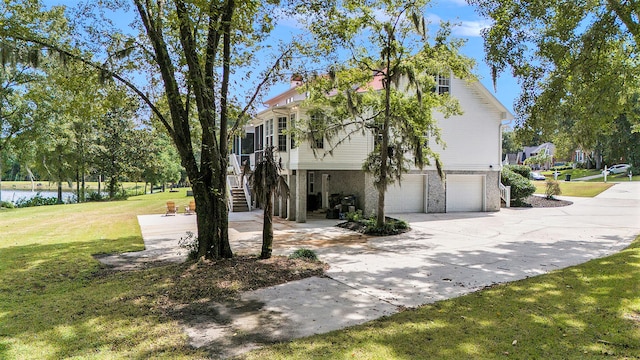 view of front of house with a garage and a front lawn