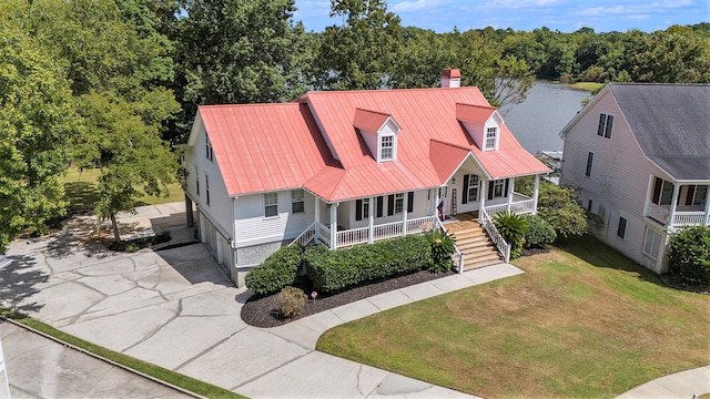 cape cod home featuring a front yard and a porch