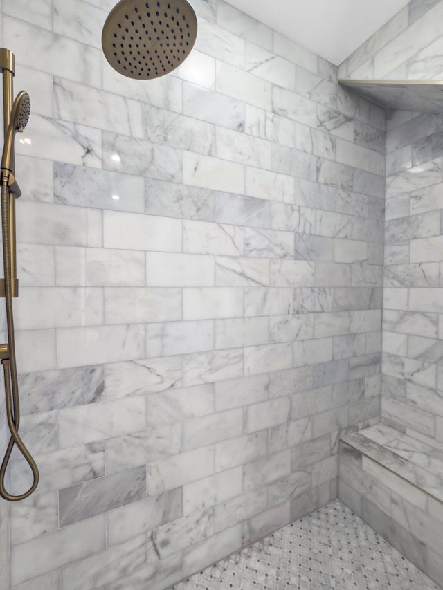 bathroom with tiled shower