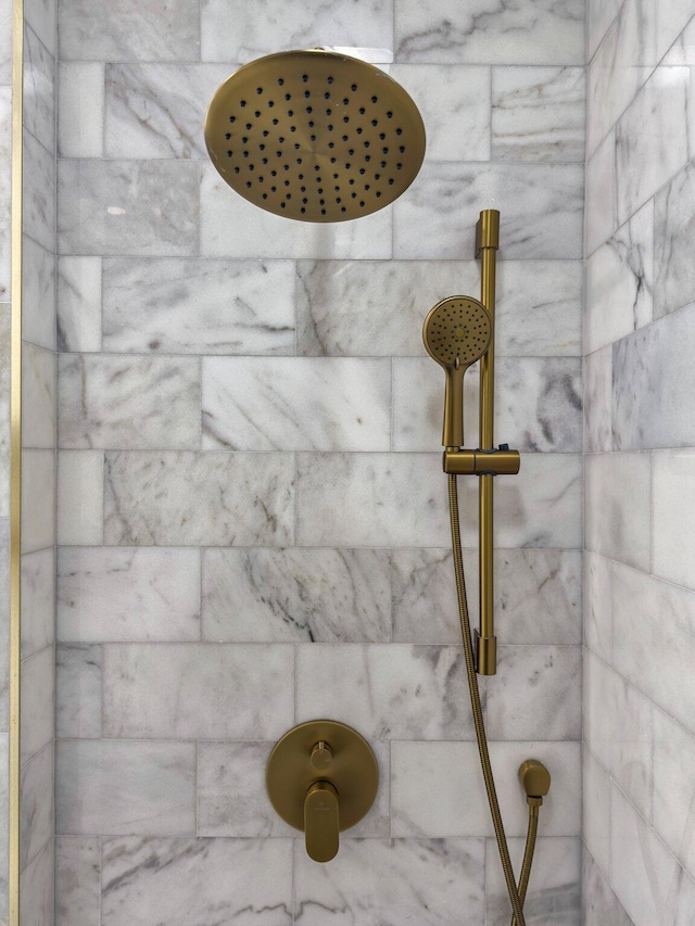 interior details featuring a tile shower