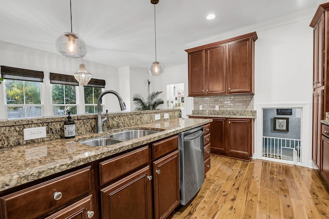 kitchen featuring light wood finished floors, ornamental molding, backsplash, stainless steel dishwasher, and a sink