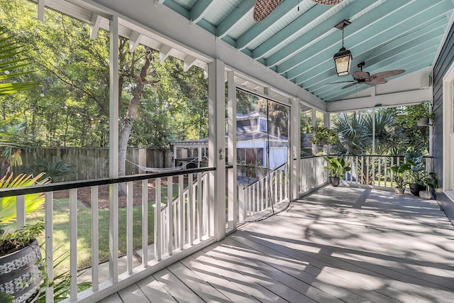 wooden terrace featuring ceiling fan and fence