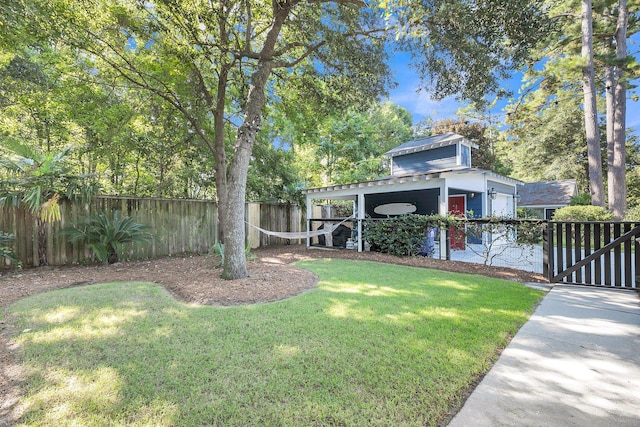 view of yard with fence and an attached garage