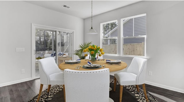 dining room with dark hardwood / wood-style flooring