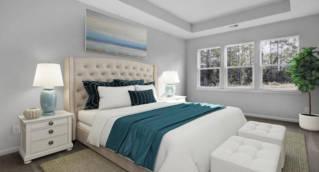 carpeted bedroom featuring a tray ceiling