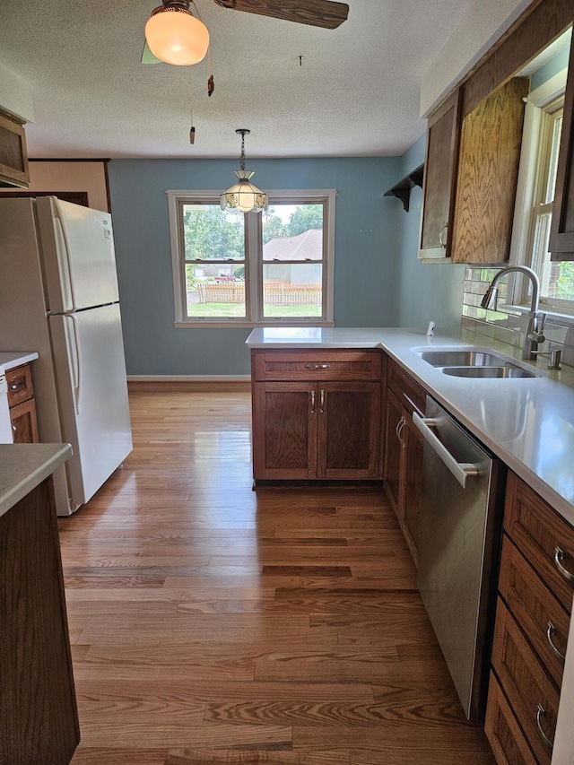 101 Brittany Ct, Summerville, SC 29485 - kitchen featuring freestanding refrigerator, stainless steel dishwasher, light wood-style flooring, a sink, and a peninsula