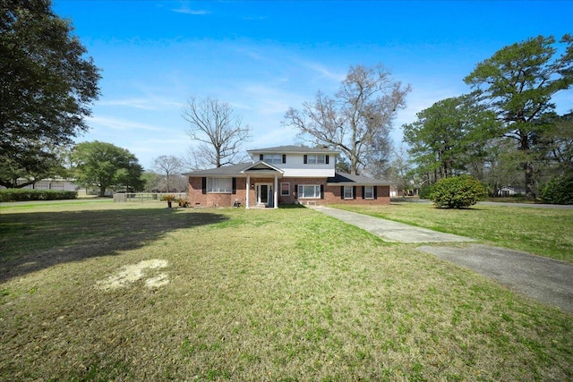 view of front of property with brick siding and a front lawn