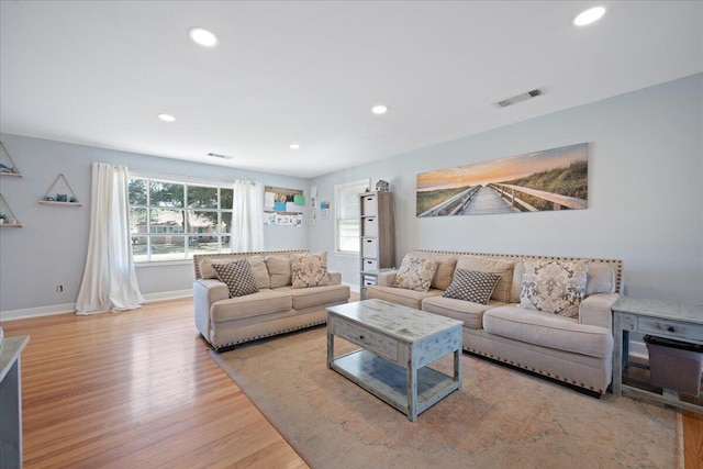 living room with visible vents, recessed lighting, baseboards, and wood finished floors