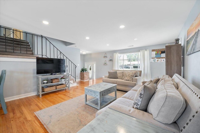 living room featuring stairway, recessed lighting, baseboards, and wood finished floors