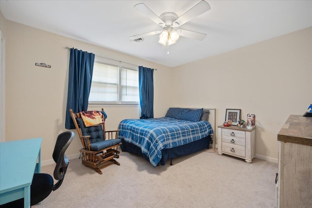 carpeted bedroom featuring visible vents, baseboards, and ceiling fan