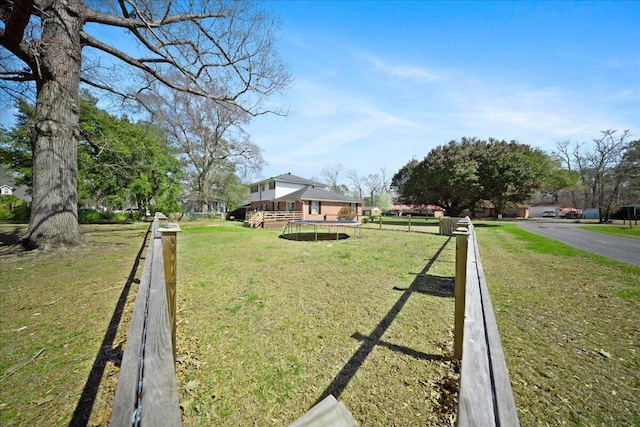 view of yard featuring a wooden deck and fence