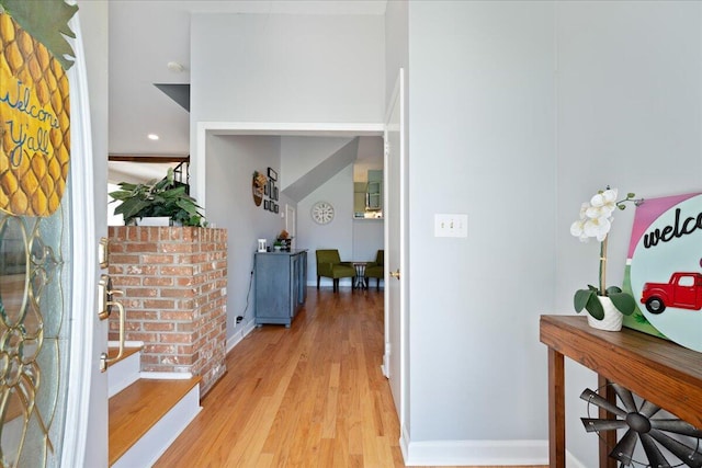 foyer with baseboards and light wood-style flooring