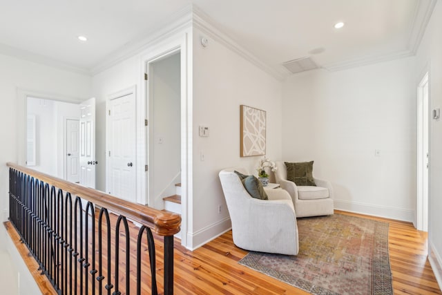 sitting room featuring crown molding and light hardwood / wood-style floors