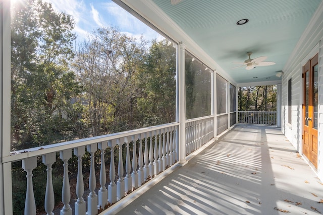 unfurnished sunroom with ceiling fan and a healthy amount of sunlight