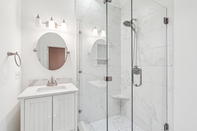 bathroom featuring an enclosed shower and vanity