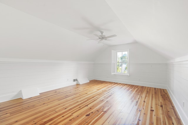 additional living space with vaulted ceiling, ceiling fan, and light hardwood / wood-style flooring