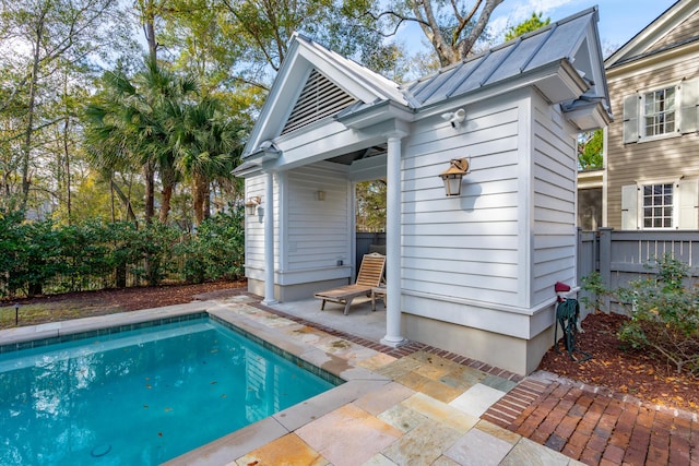 back of house featuring a patio area and an outdoor structure