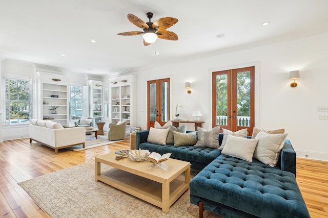 living room featuring ceiling fan, light hardwood / wood-style flooring, french doors, and a healthy amount of sunlight