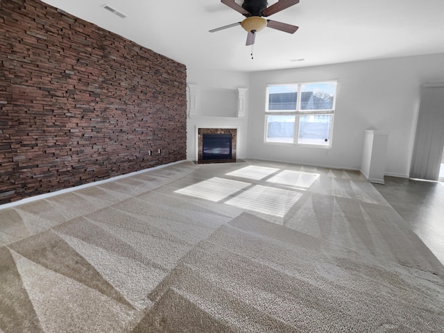 unfurnished living room with ceiling fan and a premium fireplace