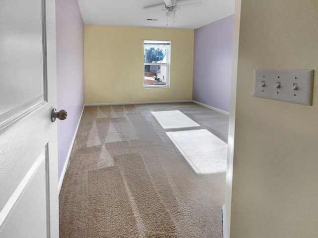 carpeted empty room featuring ceiling fan