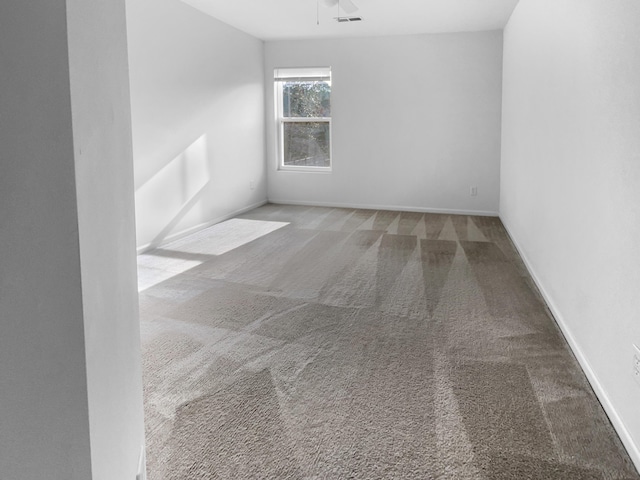 carpeted spare room featuring ceiling fan