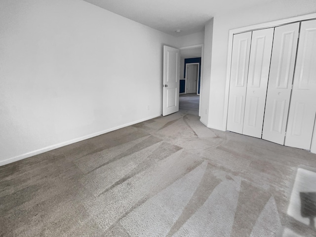 unfurnished bedroom featuring carpet floors and a closet