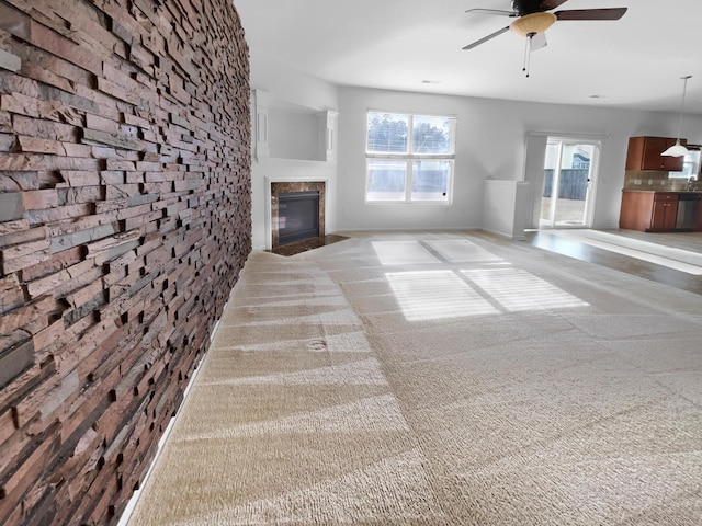 unfurnished living room featuring ceiling fan and light colored carpet