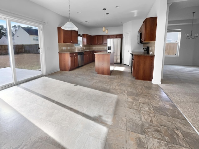 kitchen with plenty of natural light, a kitchen island, and appliances with stainless steel finishes