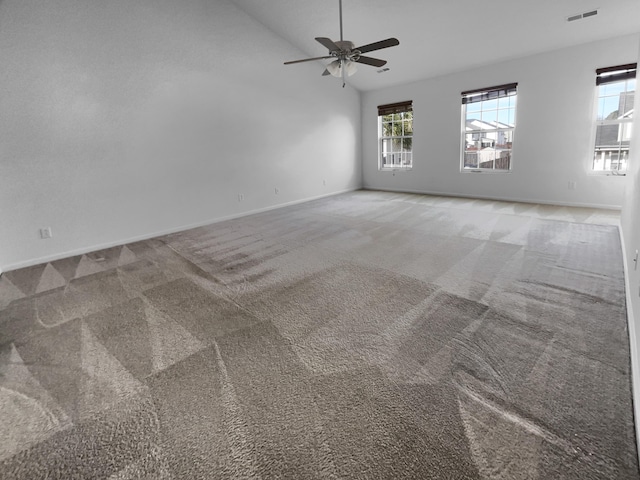 spare room featuring ceiling fan, carpet, and lofted ceiling