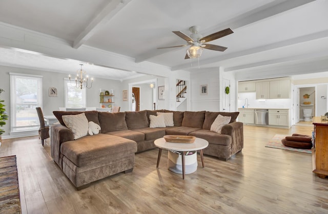 living room featuring ceiling fan with notable chandelier, beam ceiling, light hardwood / wood-style floors, and sink